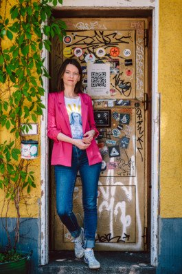 Portrait von einem vollbärtigen Mann mit kurzen Haaren, der in die Kamera lächelt. Er trägt ein Shirt mit einem Fahrrad.