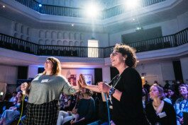 Portrait von einem vollbärtigen Mann mit kurzen Haaren, der in die Kamera lächelt. Er trägt ein Shirt mit einem Fahrrad.