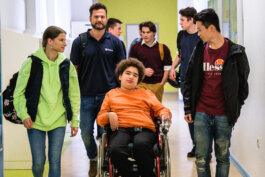 Portrait von einem vollbärtigen Mann mit kurzen Haaren, der in die Kamera lächelt. Er trägt ein Shirt mit einem Fahrrad.